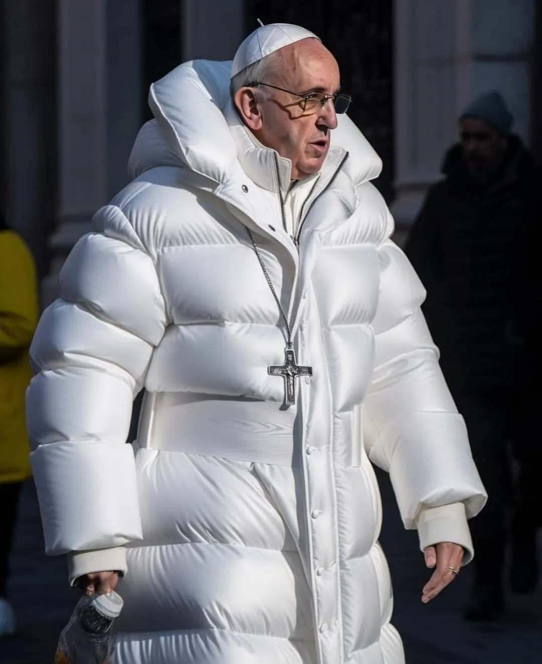 Pope Francis walking in a long white puffer jacket